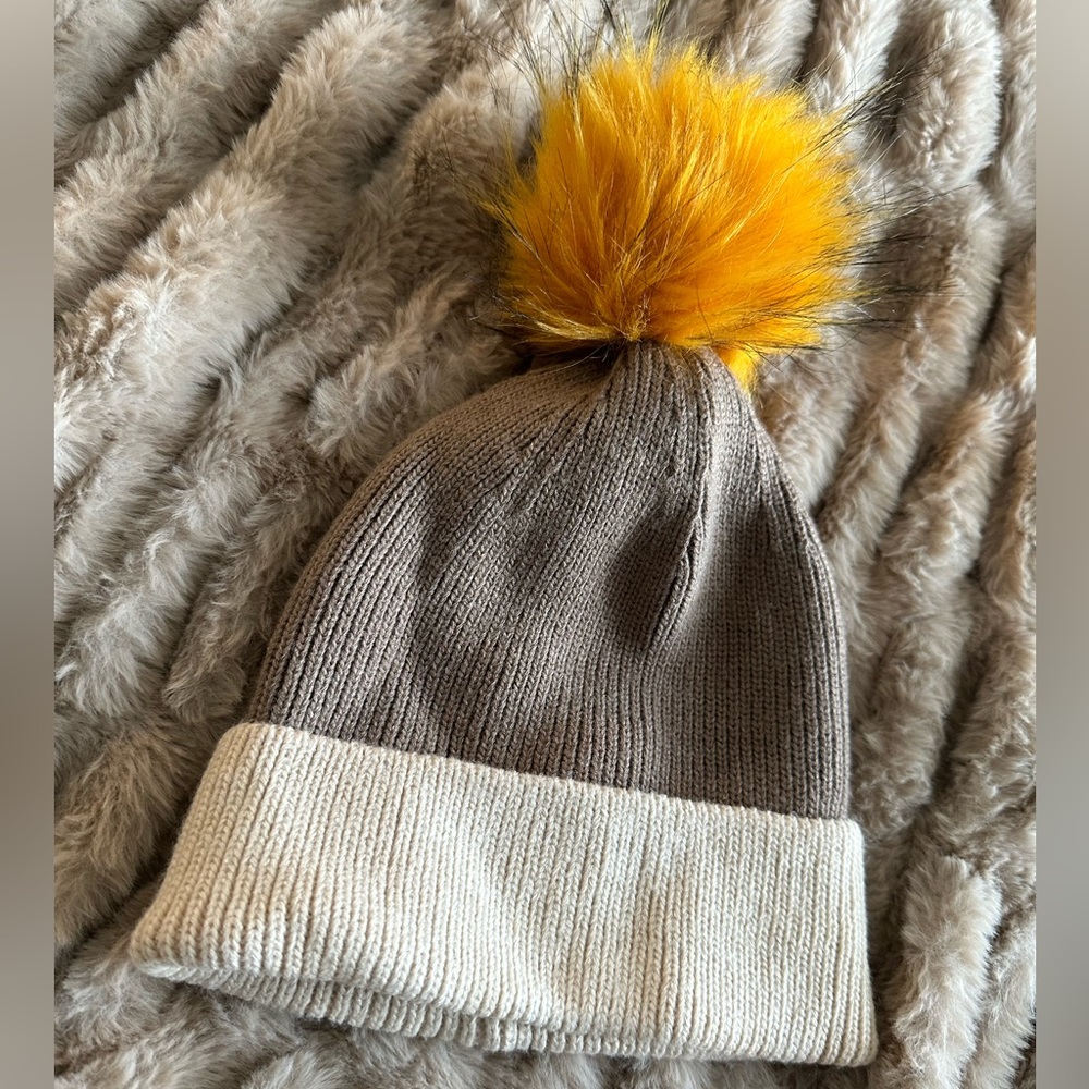 Tan, brown beanie with yellow poof